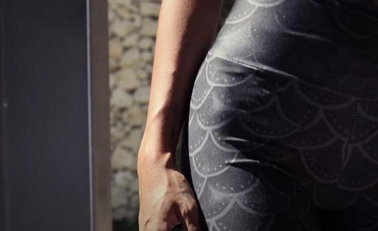 Close-up image of hips wearing Love Her leggings.