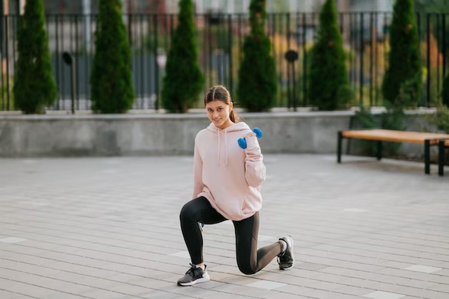 Woman in sweatshirt exercising